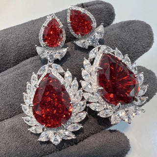 Rouge Teardrop Earrings: 925 sterling silver teardrop earring studs set with lab-created ruby sapphires, weighing 31 grams.