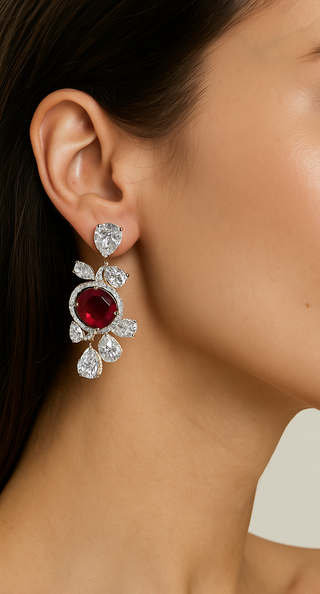 Ruby Waltz Jhumka earrings in 925 sterling silver set with lab-made ruby sapphires and side stones.