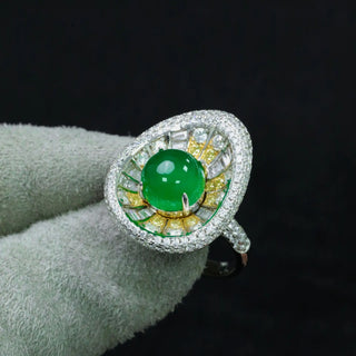 Sterling silver sunburst ring featuring a central jade stone with radiating yellow and white lab sapphires in a vibrant, green statement design.