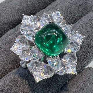 Azzallure Sugar-Loaf Emerald Ring featuring a domed lab-created emerald in a prong setting, flanked by lab sapphires on polished sterling silver.

