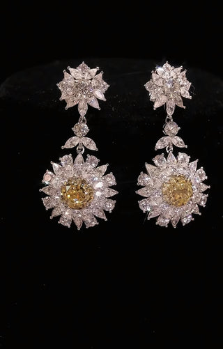 Sunflower's Embrace Earrings in sterling silver with platinum plating and yellow lab sapphires, radiating warmth and elegance.