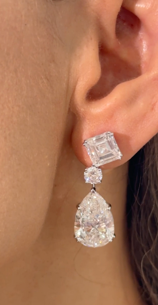 The Celestial Drops earrings: 18K white gold drop earrings with a 4 ct Asscher-cut, 0.5 ct round, and 10 ct pear-shaped lab-grown diamonds (29 ct total).