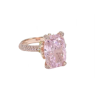 The Garden of Aurora Ring featuring an 8-carat pink lab-created sapphire in a rose gold setting, surrounded by sparkling lab sapphires. A symbol of love and new beginnings.

