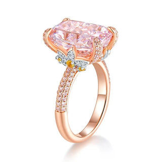 The Garden of Aurora Ring featuring an 8-carat pink lab-created sapphire in a rose gold setting, surrounded by sparkling lab sapphires. A symbol of love and new beginnings.

