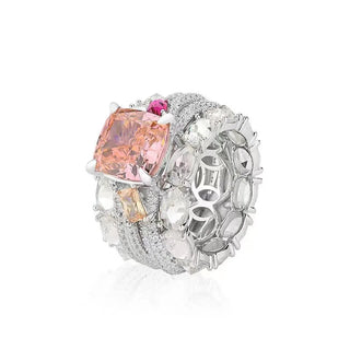 Bold sterling silver cocktail ring featuring a radiant pink lab sapphire center with pavé-set accents, designed for glamorous statement wear.