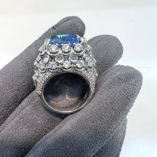 Majestic sterling silver cocktail ring featuring a large emerald-cut aquamarine centerpiece surrounded by lab-created sapphires, evoking the icy brilliance of glaciers and celestial light.
