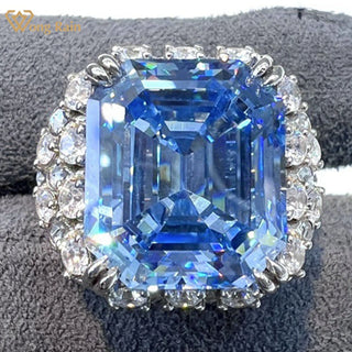 Majestic sterling silver cocktail ring featuring a large emerald-cut aquamarine centerpiece surrounded by lab-created sapphires, evoking the icy brilliance of glaciers and celestial light.