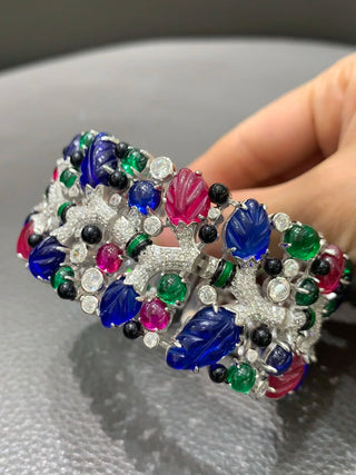 Twilight Flora silver cuff bracelet with floral design and lab sapphires – bold wrist cuff inspired by nature and twilight beauty.