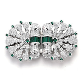 Vintage emerald clasp brooch in sterling silver with central green emerald, 57 mm wide and weighing 39 g.