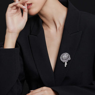 Women’s purple flower brooch adorned with lab-created sapphires in a copper and silver setting, weighing 27 grams.