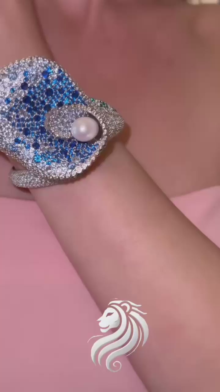 Lily’s Embrace Bracelet in 925 sterling silver featuring sculpted tulip petals, lab-created sapphires, and a central freshwater pearl