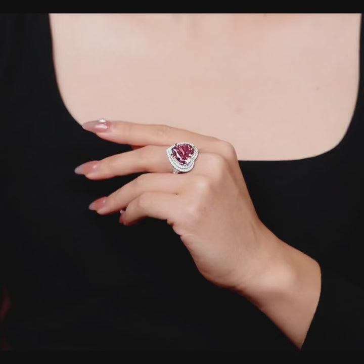 Sugar Crush Heart Ring by Azzallure featuring a pink heart-shaped lab sapphire surrounded by sparkling lab sapphires in platinum-plated sterling silver.

