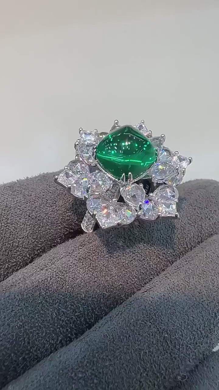 Azzallure Sugar-Loaf Emerald Ring featuring a domed lab-created emerald in a prong setting, flanked by lab sapphires on polished sterling silver.

